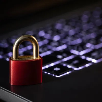 Red Padlock on Backlit Laptop Keyboard