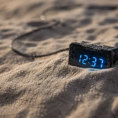 Glowing Blue Digital Clock in Sand