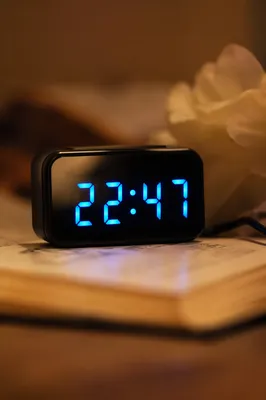 Glowing Blue Digital Clock on Open Book