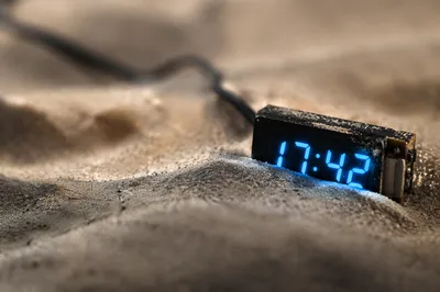 Glowing Blue Digital Clock in Sand