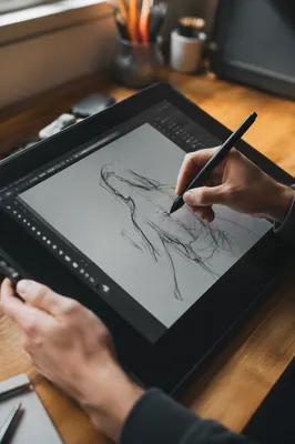 Hands Drawing on Digital Tablet Workspace