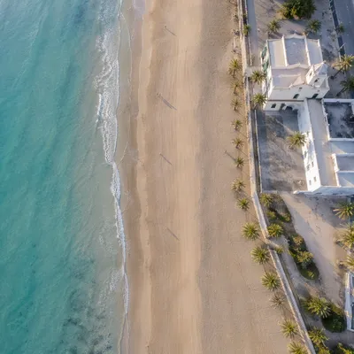 Aerial Seaside Church Along Quiet Beach