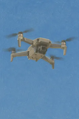 Drone Hovering in Clear Blue Sky