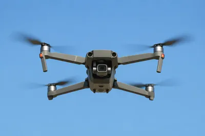 Quadcopter Drone Hovering in Clear Blue Sky