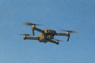 Quadcopter Drone Hovering in Clear Blue Sky