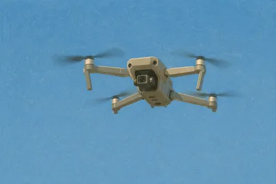 Quadcopter Drone Hovering in Clear Blue Sky