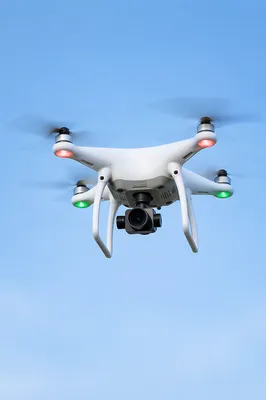 White Quadcopter Drone in Blue Sky