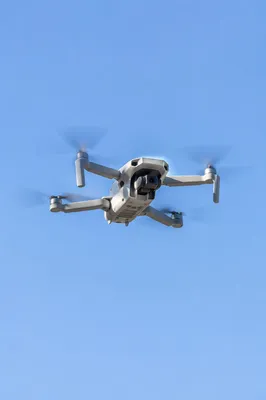Quadcopter Drone Hovering in Clear Blue Sky