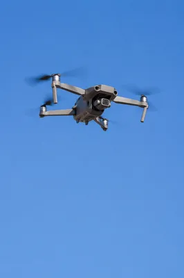 Compact Quadcopter Drone in Clear Blue Sky