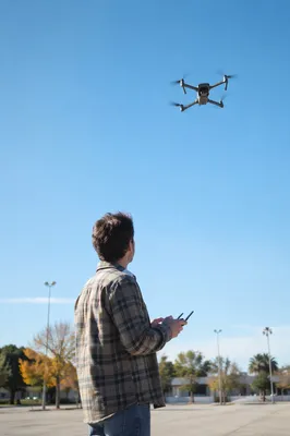 Drone Pilot Under Clear Blue Sky