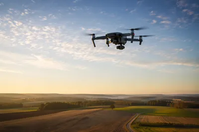 Camera Drone Hovering Over Sunrise Fields