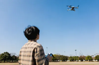 Drone Operator Under Clear Blue Sky