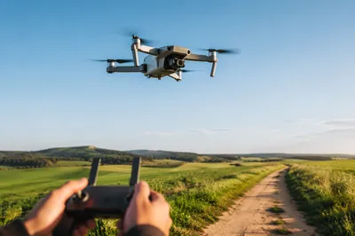 Camera Drone Hovering Over Green Fields