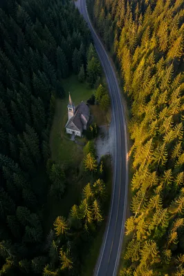 Aerial Church in Forest Clearing