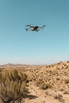 Drone Hovering Above Desert Landscape Sky