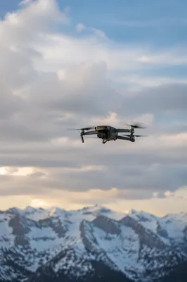 Drone Hovering Over Alpine Mountain Sky