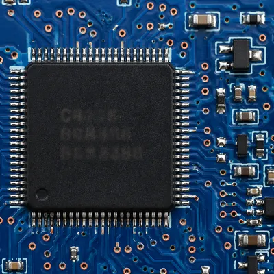 Macro Microchip on Blue Circuit Board
