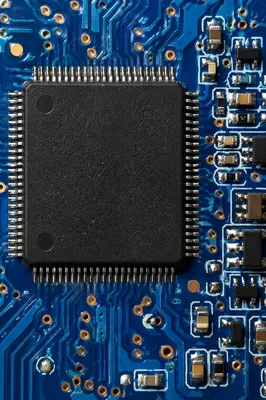 Macro Microchip on Blue Circuit Board