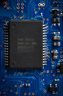 Macro Microchip on Blue Circuit Board