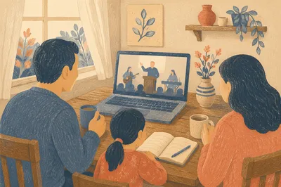 Family Watching Livestream on Laptop at Table