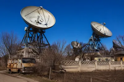 Rural Satellite Dishes Under Clear Blue Sky