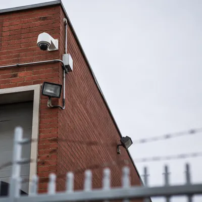 Dome Security Camera on Brick Building Wall