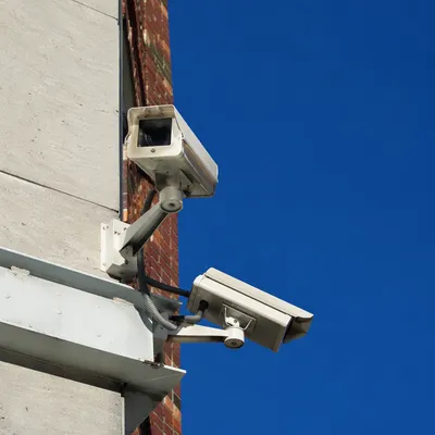 Building Security Cameras Under Blue Sky