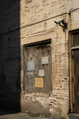 Security Camera on Weathered Brick Wall