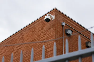 Dome Security Camera on Brick Building Wall