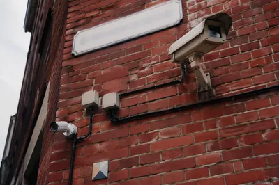 Outdoor Surveillance Cameras on Brick Wall