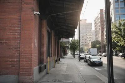 Urban Security Camera on Brick Building Wall