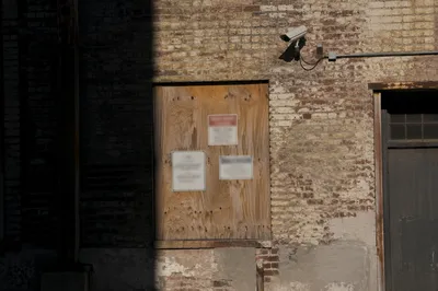 Urban Security Camera on Weathered Brick Wall