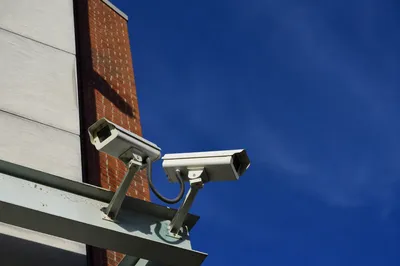 Dual Security Cameras on Modern Building Wall