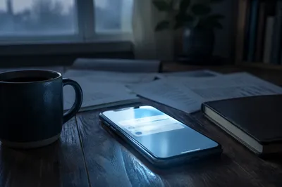Smartphone Glow on Early Morning Desk