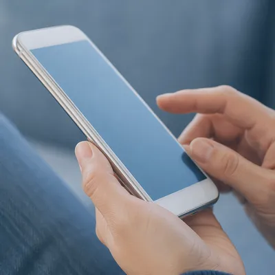 Hand Holding Smartphone With Blue Screen