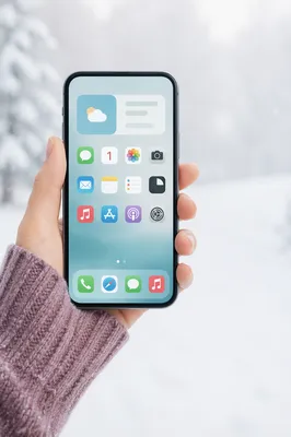 Hand Holding Smartphone in Snowy Winter Light