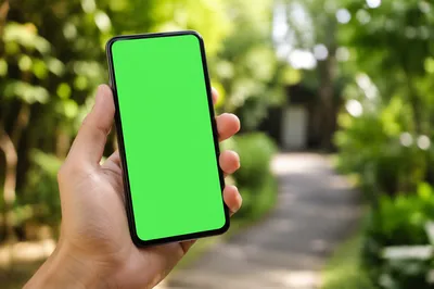Hand Holding Smartphone With Green Screen