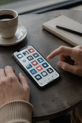 Smartphone Social Media Icons on Cafe Table