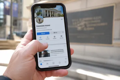 Hand Holding Smartphone in Outdoor Plaza