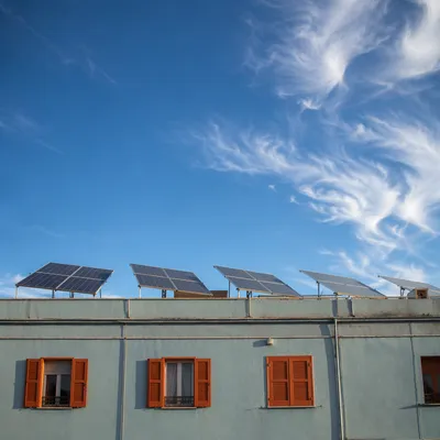 Residential Rooftop Solar Panels Under Blue Sky