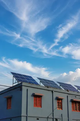 Rooftop Solar Panels Under Expansive Blue Sky