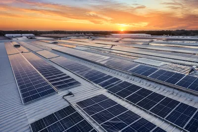 Sunset Solar Panels on Industrial Rooftop