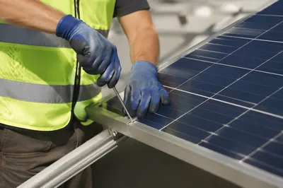 Solar Technician Installing Rooftop Panel