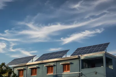 Rooftop Solar Panels Under Expansive Blue Sky