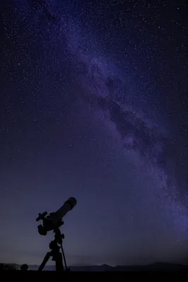 Silhouetted Telescope Beneath Vast Starry Sky