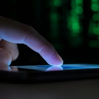 Fingertip Tapping Glowing Smartphone Screen Closeup