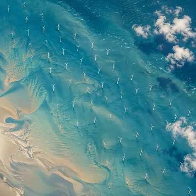 Aerial Offshore Wind Farm Over Turquoise Sea