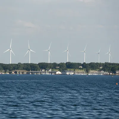 Coastal Wind Turbines Over Quiet Inlet