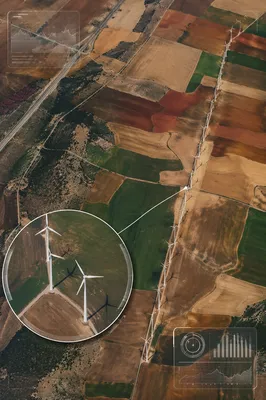 Aerial Wind Turbines Over Farmland