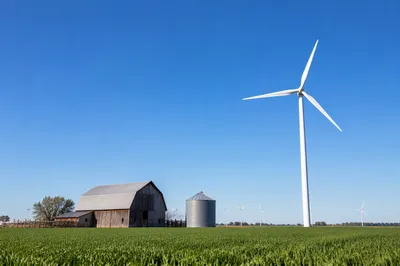 Wind Turbine Over Green Farm Fields